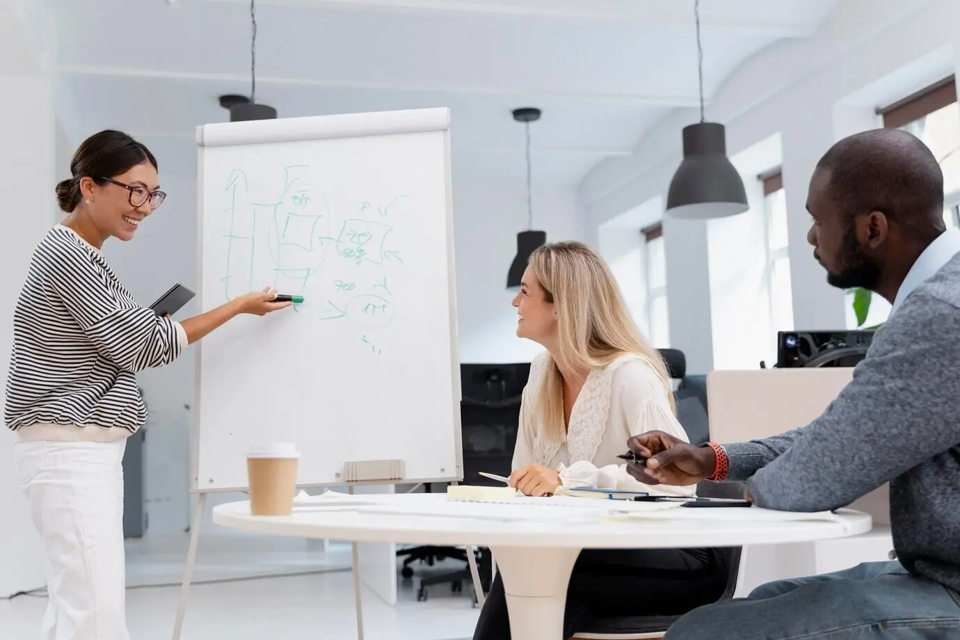 Close-up of young coworkers in a meeting.